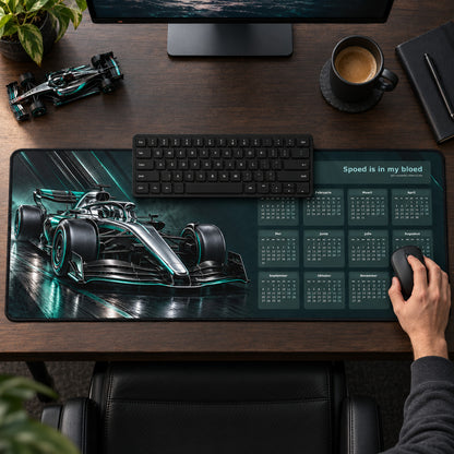 Carbon and Chrome 2027 calendar desk pad in use with a computer mouse on a styled desk.