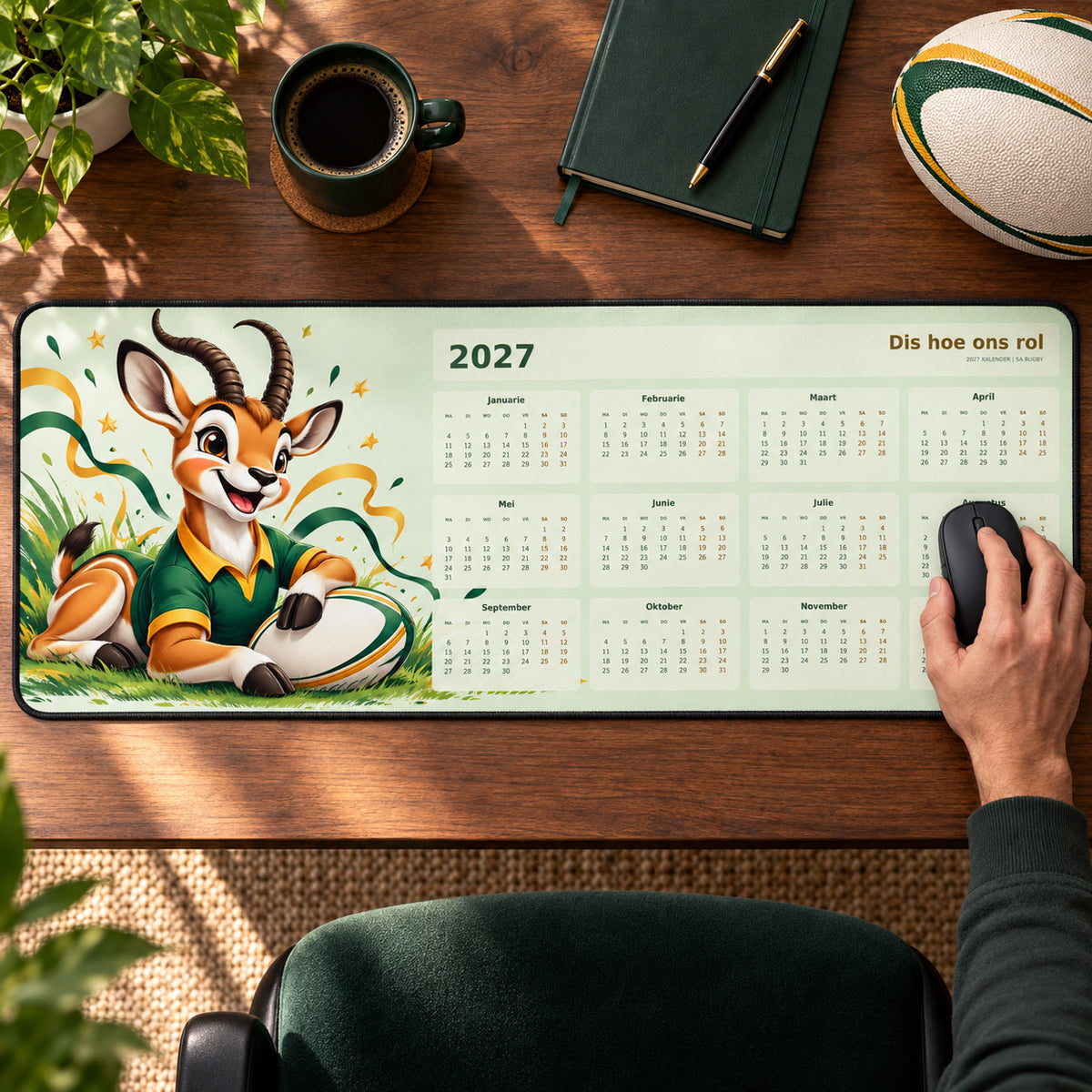 Cheerful Bokke Mascot 2027 calendar desk pad in use with a computer mouse on a styled desk.