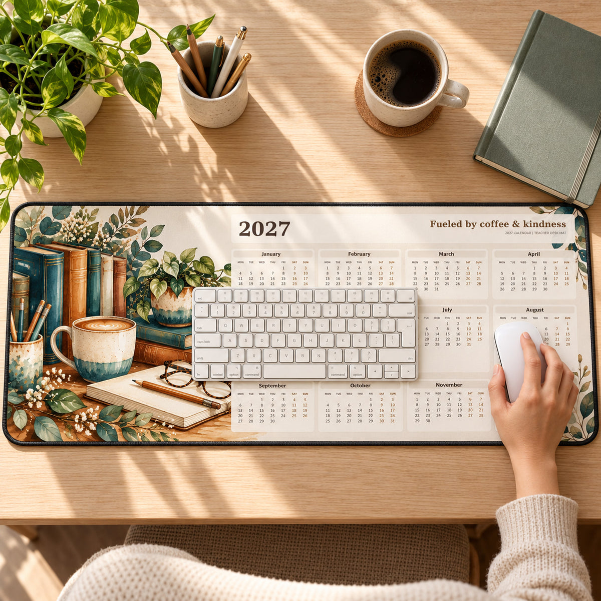 Books and Coffee 2027 calendar desk pad in use with a computer mouse on a styled desk.