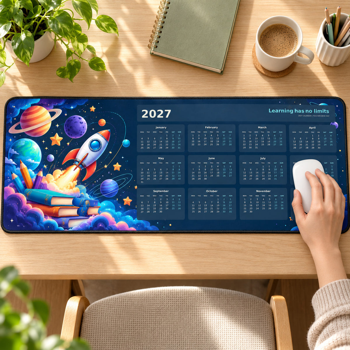 Classroom Space Explorer 2027 calendar desk pad in use with a computer mouse on a styled desk.